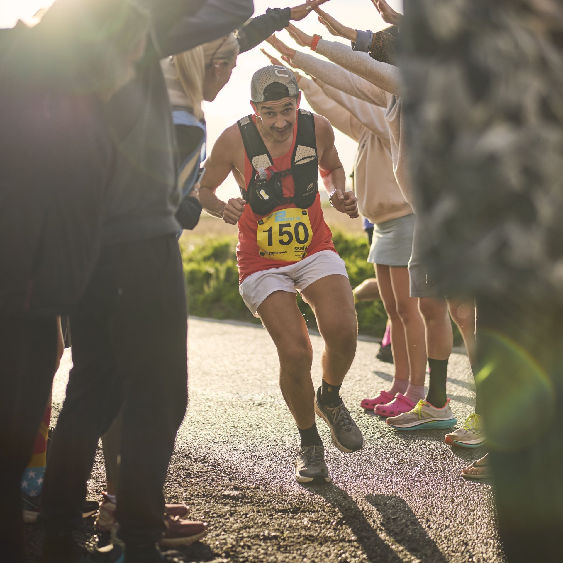 Runner participating in Run2Paris relay from London to Paris, running through scenic countryside.