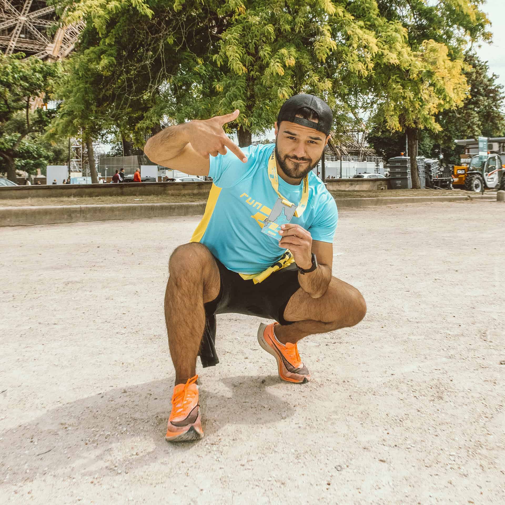 Runner celebrating at Run2Paris relay event, highlighting London to Paris marathon.